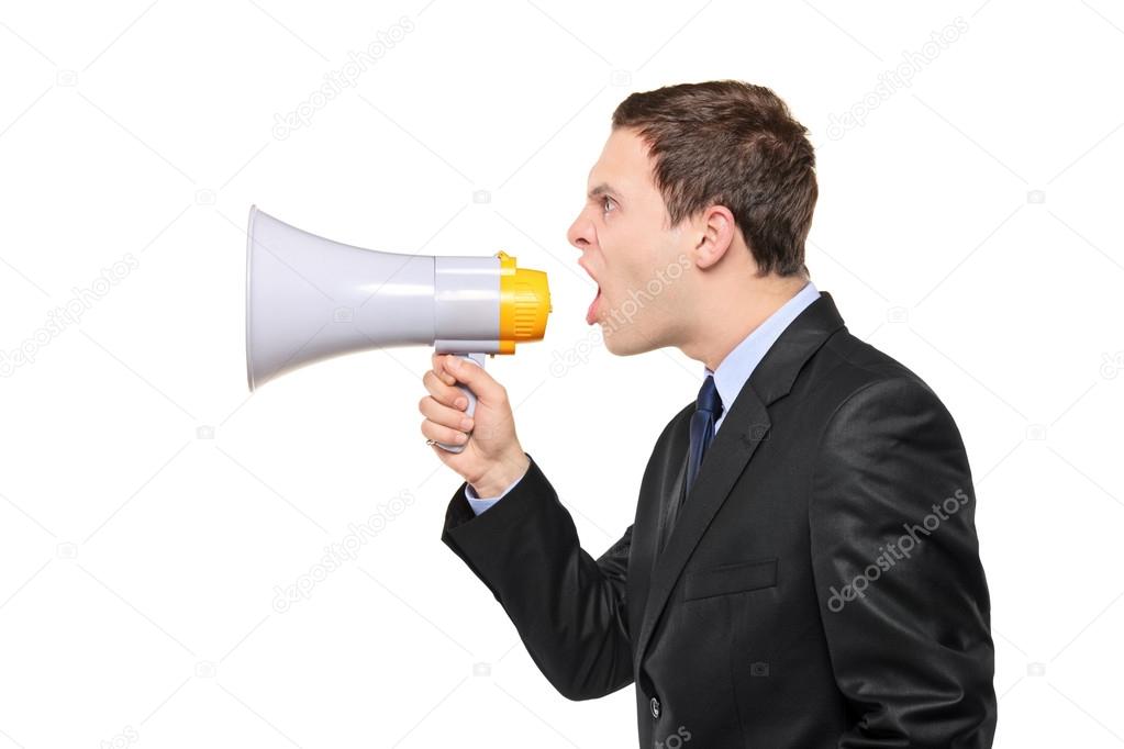 Young businessman shouting on megaphone