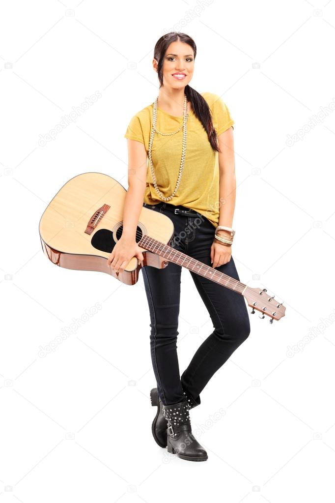 Female musician holding acoustic guitar