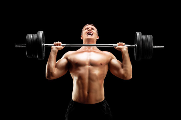 Handsome sportsman lifting heavy weight