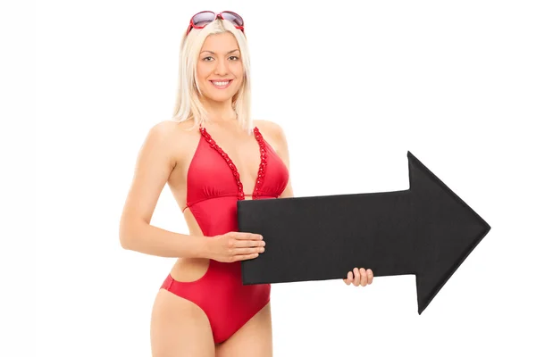 Woman in swimsuit holding arrow — Stock Photo, Image