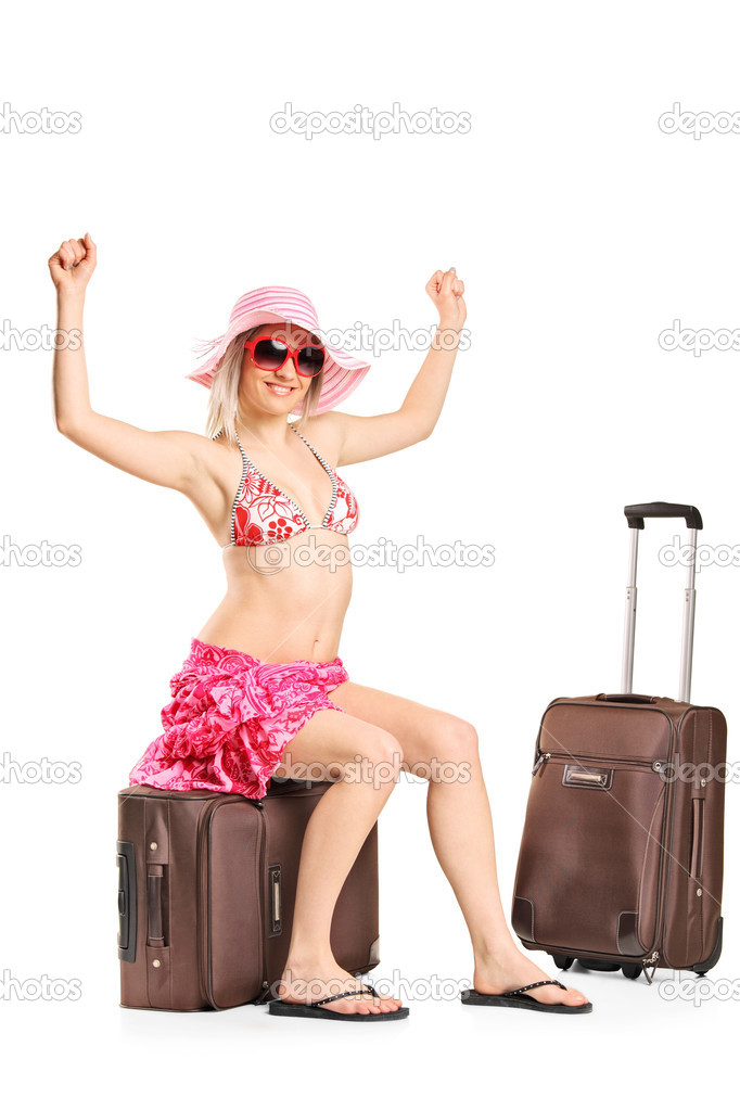 Woman sitting on her baggage