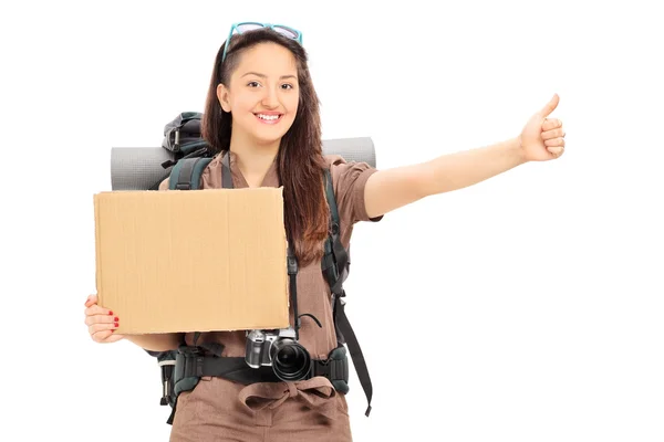 Female hitchhiker holding blank banner — Stock Photo, Image