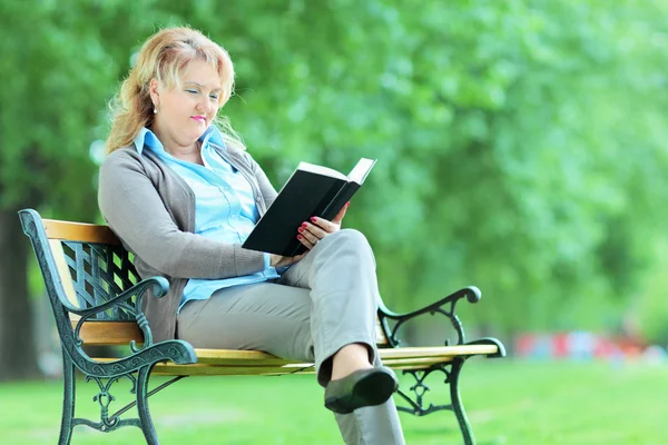 Mature woman reading book — Stock Photo, Image