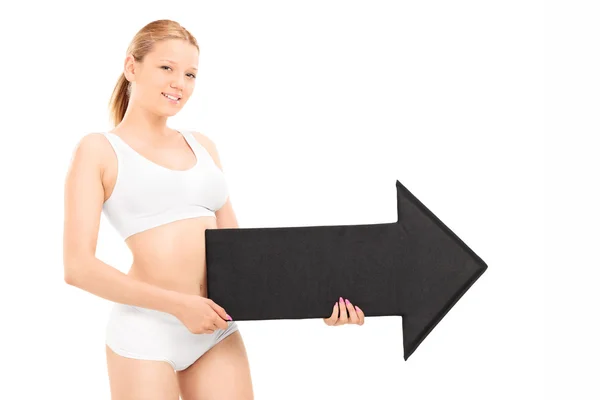 Woman in underwear holding arrow — Stock Photo, Image