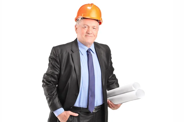 Mature engineer holding construction plans — Stock Photo, Image