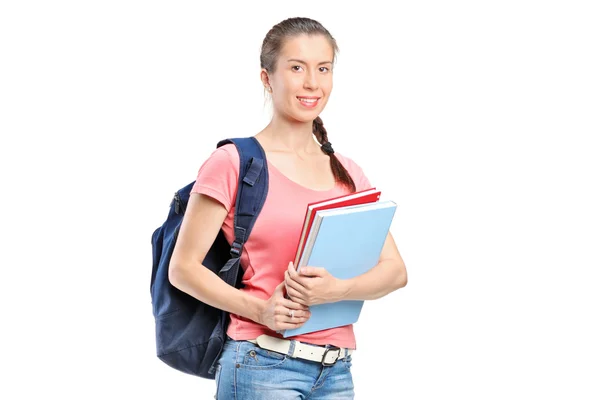 Schoolgirl with backpack holding notebooks — Stock Photo, Image