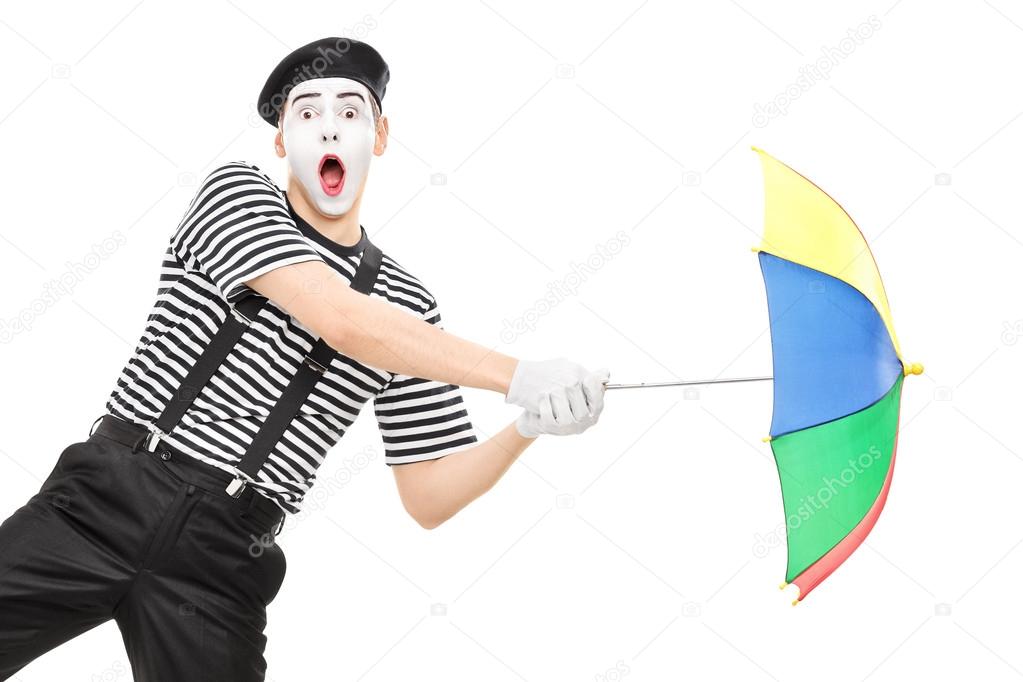 Mime artist holding umbrella