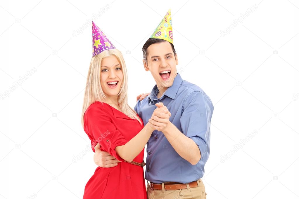 Couple with party hats dancing
