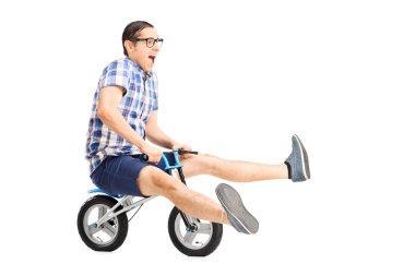 Young guy riding small bike clipart