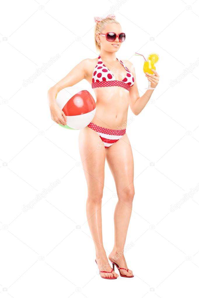 Woman in bikini drinking cocktail