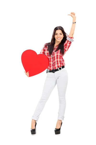 Attractive woman holding red heart — Stock Photo, Image