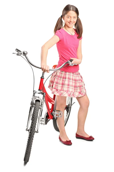 Teenage girl standing by bicycle — Stock Photo, Image