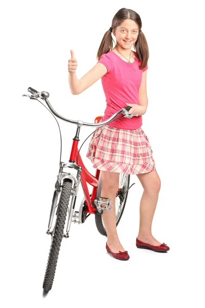 Teen girl standing by bike — Stock Photo, Image