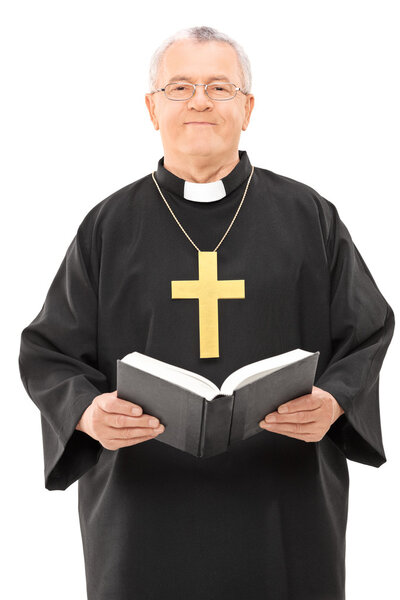 Mature priest holding holy bible