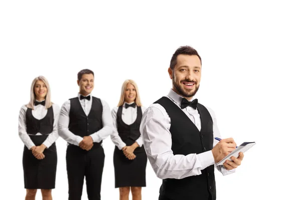 Waiter Bow Tie Writing Other Waiters Standing Back Isolated White — Stock Photo, Image
