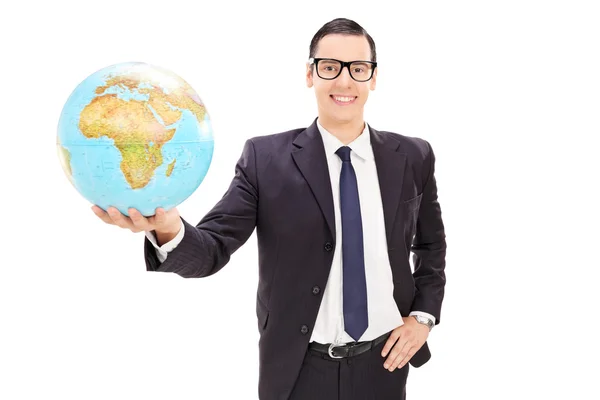 Young businessman holding globe — Stock Photo, Image