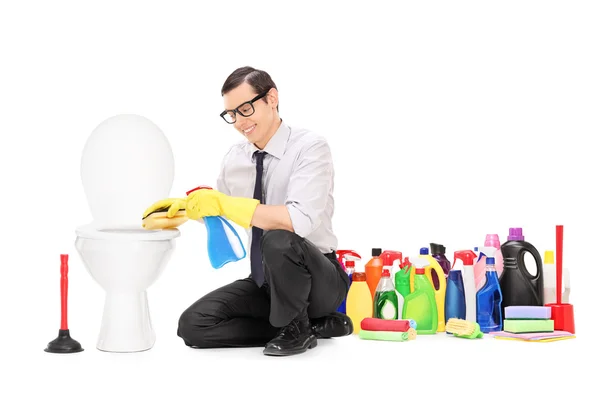 Man sitting by toilet — Stock Photo, Image