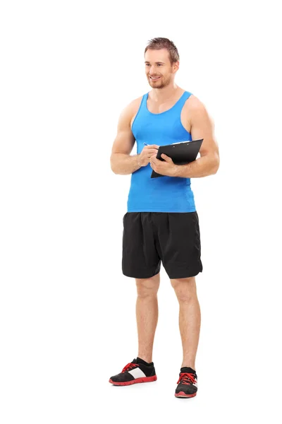 Fitness coach holding clipboard — Stock Photo, Image