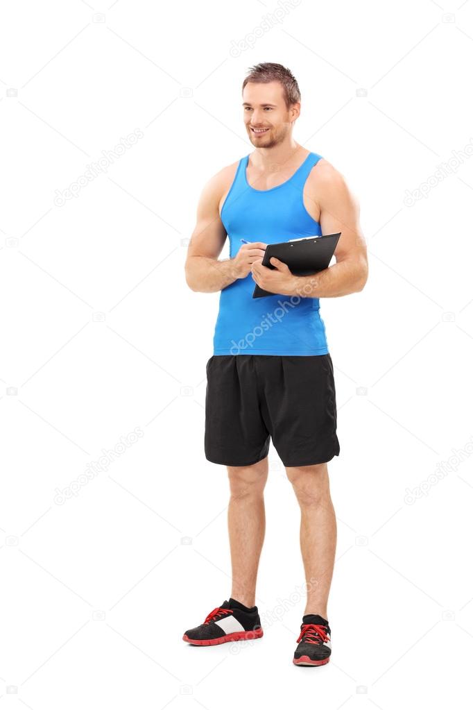 Fitness coach holding clipboard