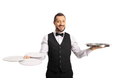 Professional waiter holding empty plates and a silver tray isolated on white background clipart
