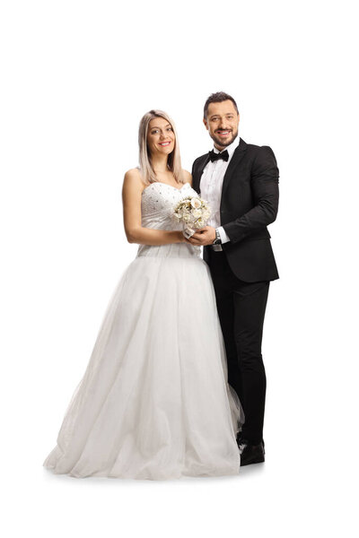 Full length portrait of a happily married bride and groom isolated on white background