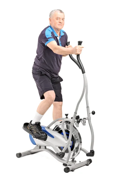 Man on cross trainer machine — Stock Photo, Image