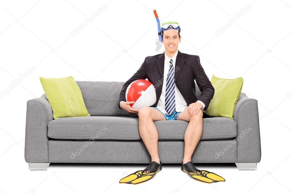 Man with snorkel on sofa