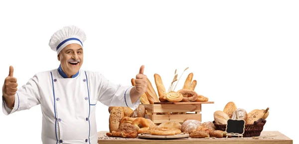 Cheerful Male Chef Variety Bread Loaves Smiling Showing Thumbs Isolated — Stock Photo, Image