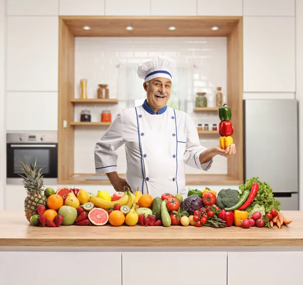 Mature Male Chef Holding Pile Bell Peppers Standing Fruits Vegetables — Stock Photo, Image