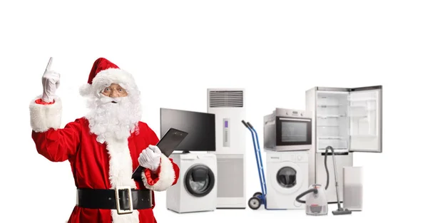 Papai Noel Frente Eletrodomésticos Segurando Uma Área Transferência Apontando Para — Fotografia de Stock