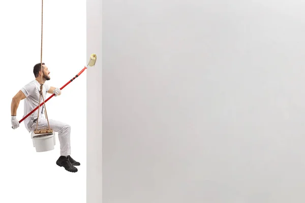 Side Shot Painter Sitting Swing Painting Wall Paint Roller Isolated — Stock Photo, Image