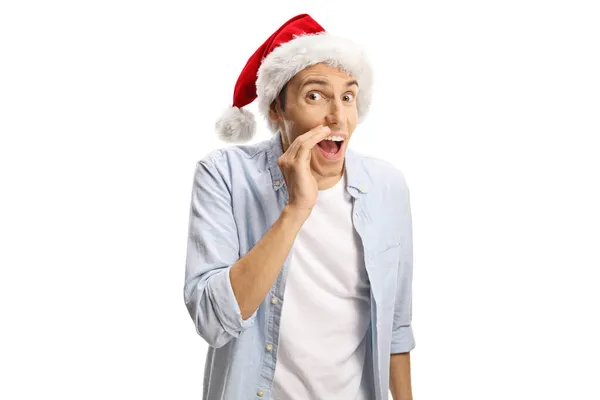 Молодой Человек Шляпе Санта Клауса Шепчет Тайну Изолированы Белом Фоне — стоковое фото