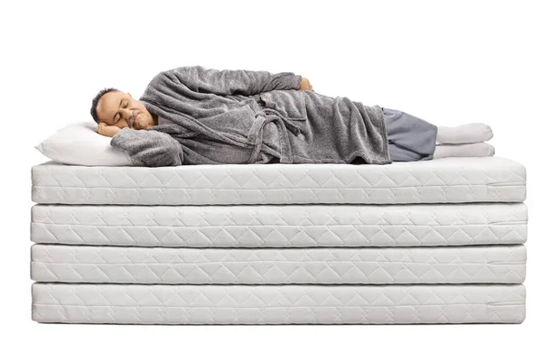 Mature Man Bathrobe Sleeping Pile Mattresses Isolated White Background — Stock Photo, Image