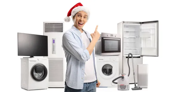 Jovem Feliz Com Chapéu Papai Noel Apontando Para Eletrodomésticos Isolados — Fotografia de Stock
