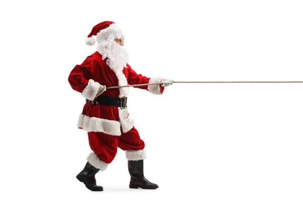 Full Length Profile Shot Santa Claus Τραβώντας Ένα Σχοινί Απομονωμένο — Φωτογραφία Αρχείου