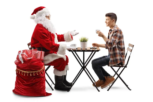 Der Weihnachtsmann Trinkt Kaffee Und Spricht Mit Einem Teenager Der — Stockfoto
