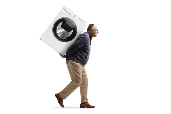 一个男人背着洗衣机 背靠在白色背景上被隔离的全身像照片 — 图库照片