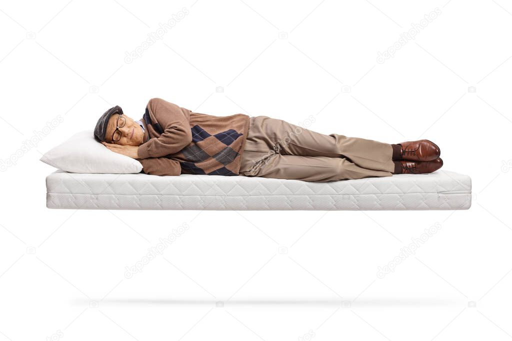 Senior man sleeping on a floating matress isolated on white background