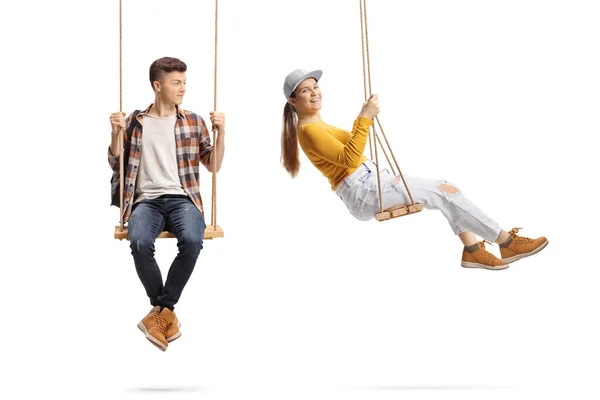 Male Teen Sitting Swing Looking Young Female Swinging Isolated White — Stock Photo, Image