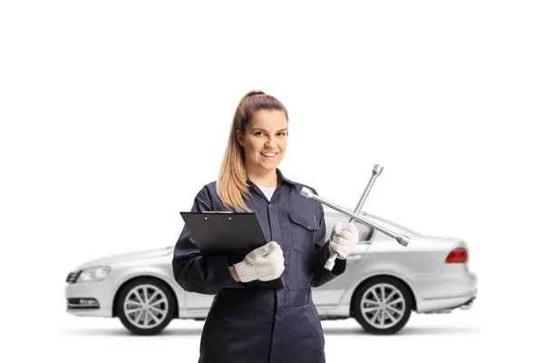 Female Auto Mechanic Holding Lug Wrench Front Silver Car Isolated — Stock Photo, Image