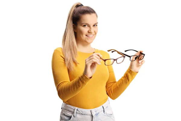 Young Female Holding Two Pairs Eyeglasses Smiling Camera Isolated White — Stock Photo, Image