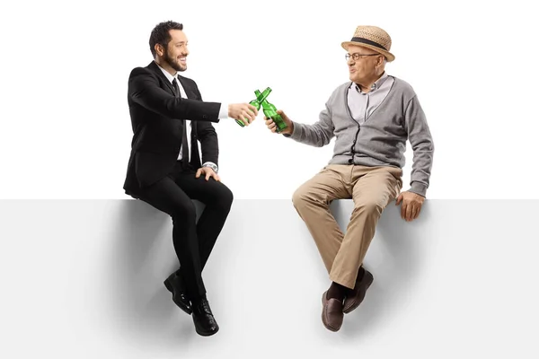 Elderly Man Young Businessman Sitting Blank Panel Toasting Bottles Beer — Stock Photo, Image