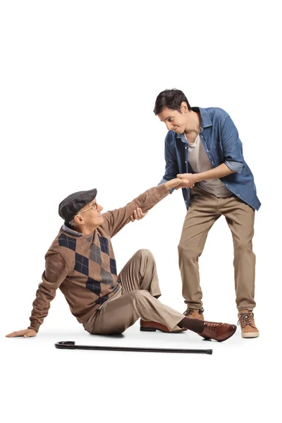 Young Man Helping Elderly Man Cane Seated Floor Isolated White — Stock Photo, Image