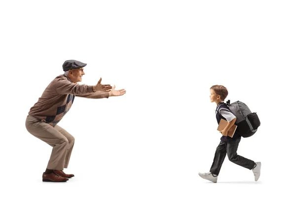 Full Length Profile Shot Schoolboy Running His Grandfather Isolated White — Stock Photo, Image