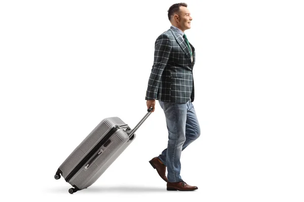 Full Length Profile Shot Man Suit Jeans Walking Pulling Suitcase — Stockfoto