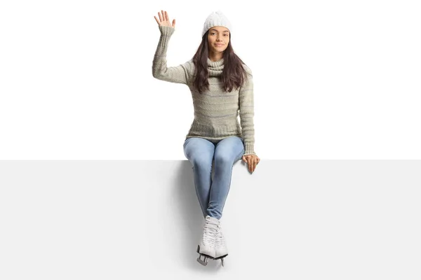 Casual Young Female Ice Skates Sitting Blank Panel Waving Isolated — стоковое фото