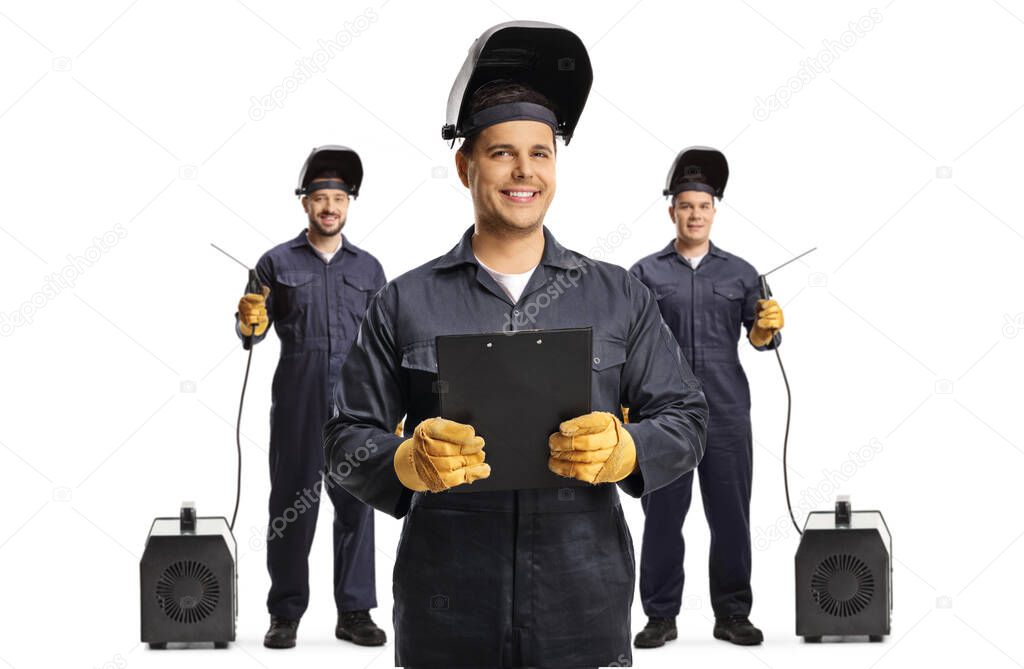 Welders holding a clipboard and standing in front of other welders with welding machines isolated on white background