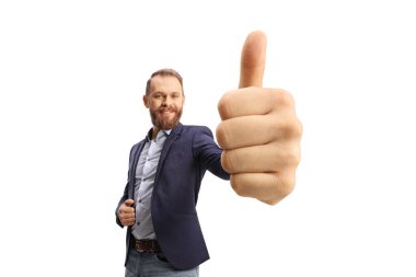 Smiling beared man gesturing a thumb up sign in front of camera isolated on white background