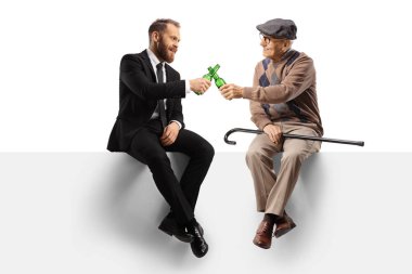 Businessman and an elderly manseated on a panel with bottles of beer isolated on white background