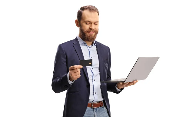 Bearded Young Man Looking Credit Card Holding Laptop Computer Isolated — Photo